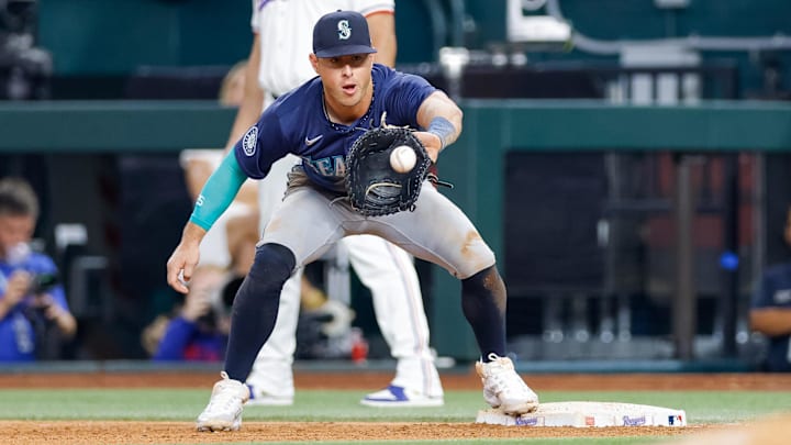 Seattle Mariners first baseman Dylan Moore catches a throw against the Texas Rangers on Sept. 21 at Globe Life Field. Seattle Mariners first baseman Dylan Moore catches a throw against the Texas Rangers on Sept. 21 at Globe Life Field.