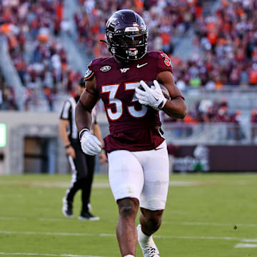 Sep 7, 2024; Blacksburg, Virginia, USA; Virginia Tech Hokies running back Bhayshul Tuten (33) runs for a touchdown during the second quarter against the Marshall Thundering Herd at Lane Stadium. Mandatory Credit: Peter Casey-Imagn Images