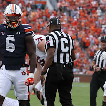 Sep 28, 2024; Auburn, Alabama, USA;  Auburn Tigers linebacker Austin Keys (6) reacts after tackling Oklahoma Sooners quarterback Michael Hawkins Jr. (9) during the first quarter at Jordan-Hare Stadium.