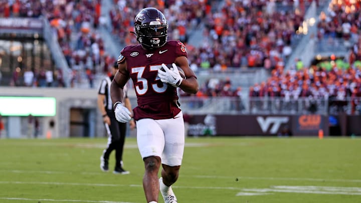 Sep 7, 2024; Blacksburg, Virginia, USA; Virginia Tech Hokies running back Bhayshul Tuten (33) runs for a touchdown during the second quarter against the Marshall Thundering Herd at Lane Stadium. Mandatory Credit: Peter Casey-Imagn Images