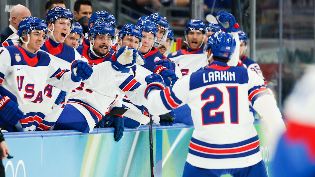 Feb 20, 2026; Milan, Italy; Dylan Larkin (21) of the United States celebrates with teammates after scoring a goal during the first period against Slovakia in a men's ice hockey semifinal during the Milano Cortina 2026 Olympic Winter Games at Milano Santagiulia Ice Hockey Arena. Mandatory Credit: Geoff Burke-Imagn Images