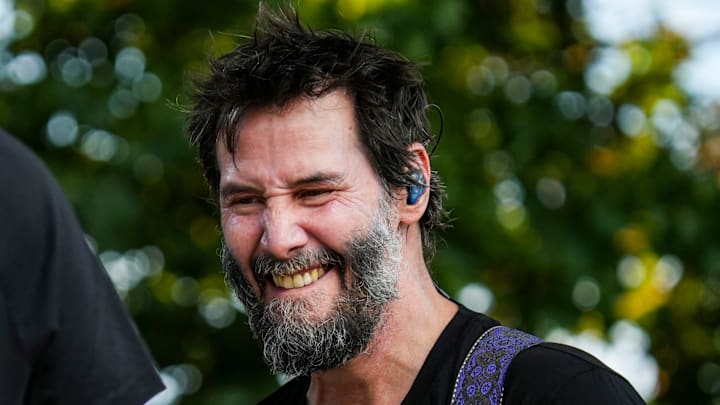 Keanu Reeves plays the bass during a performance by Dogstar