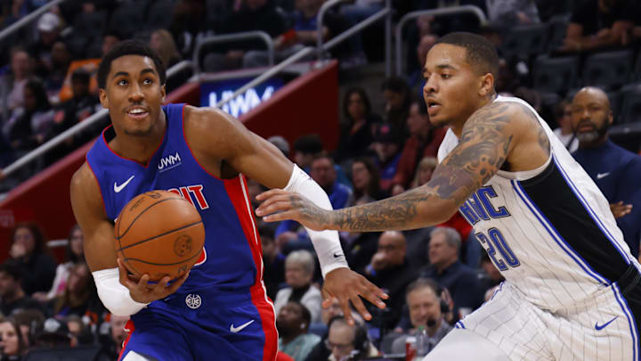 Feb 4, 2024; Detroit, Michigan, USA; Detroit Pistons guard Jaden Ivey (23) dribbles defended by Orlando Magic guard Markelle Fultz (20) in the second half at Little Caesars Arena. Mandatory Credit: Rick Osentoski-Imagn Images