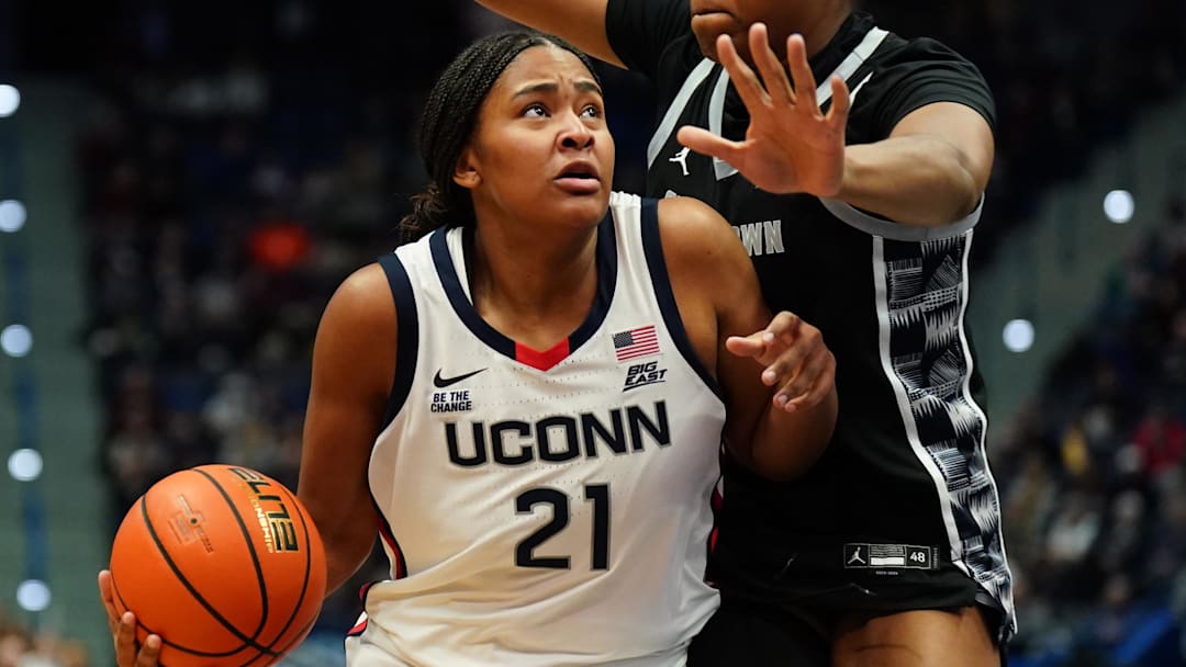 Dec 15, 2024; Storrs, Connecticut, USA; UConn Huskies forward Sarah Strong (21) drives the ball against Georgetown Hoyas center Ariel Jenkins (21) in the first half at XL Center. Mandatory Credit: David Butler II-Imagn Images