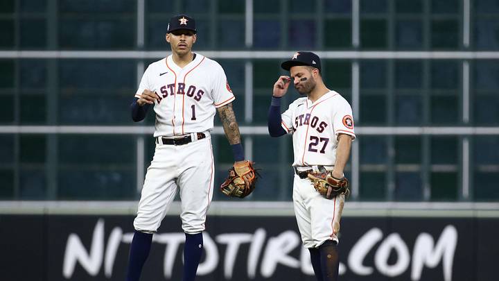 Nov 2, 2021; Houston, TX, USA; Houston Astros infielders Carlos Correa (1) and Jose Altuve (27) react during the eighth inning against the Atlanta Braves in game six of the 2021 World Series at Minute Maid Park. Mandatory Credit: Troy Taormina-Imagn Images