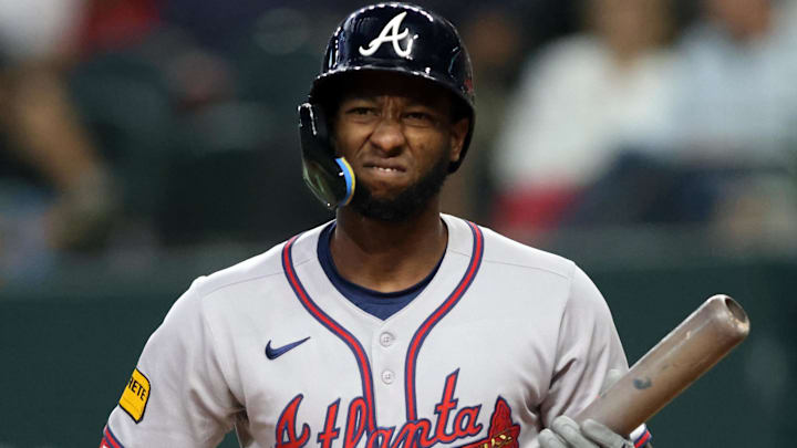 Jul 27, 2025; Arlington, Texas, USA; Atlanta Braves outfielder Jurickson Profar (7) reacts after a called third strike during the third inning against the Texas Rangers at Globe Life Field.