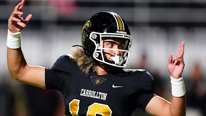 Oct 20, 2023; Carrollton, GA, USA; Carrollton Trojans quarterback Julian Lewis (10) reacts to a touchdown against the Westlake Lions during the first half at Grisham Stadium. The 15-year-old Carrollton High student has already committed to playing for the University of Southern California Trojans and has been considered one of the top high school quarterback prospects. Mandatory Credit: John David Mercer-Imagn Images