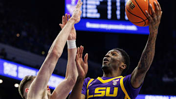 Mar 4, 2025; Lexington, Kentucky, USA; LSU Tigers guard Cam Carter (5) goes to the basket against Kentucky Wildcats forward Andrew Carr (7) during the first half at Rupp Arena at Central Bank Center. Mandatory Credit: Jordan Prather-Imagn Images