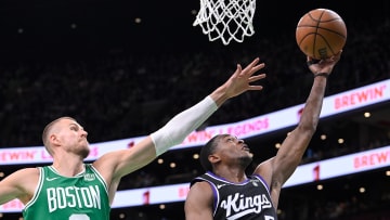 Apr 5, 2024; Boston, Massachusetts, USA; Sacramento Kings guard De'Aaron Fox (5) shoots a lay up  against Boston Celtics center Kristaps Porzingis (8) during the second half at TD Garden. Mandatory Credit: Eric Canha-USA TODAY Sports