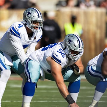 Dallas Cowboys quarterback Dak Prescott lines up behind center Cooper Beebe