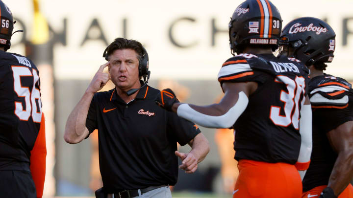 Oklahoma State coach Mike Gundy talks with his players during a Bedlam college football game between the Oklahoma State University Cowboys (OSU) and the University of Oklahoma Sooners (OU) at Boone Pickens Stadium in Stillwater, Okla., Saturday, Nov. 4, 2023. Oklahoma State won 27-24.