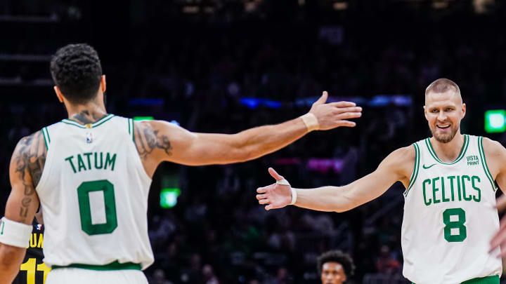 Jan 5, 2024; Boston, Massachusetts, USA;Boston Celtics center Kristaps Porzingis (8) and forward Jayson Tatum (0) react after a play against the Utah Jazz in the second quarter at TD Garden. Mandatory Credit: David Butler II-USA TODAY Sports