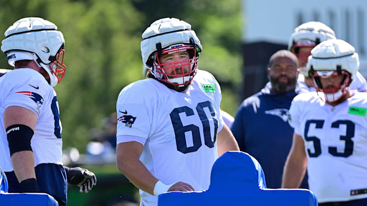Aug 1, 2023; Foxborough, MA, USA; New England Patriots center David Andrews (60) works with a tackling sled during training camp at Gillette Stadium. Mandatory Credit: Eric Canha-Imagn Images