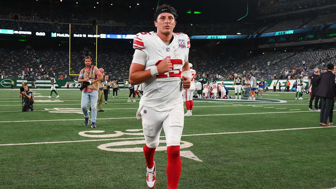 Aug 24, 2024; East Rutherford, New Jersey, USA; New York Giants quarterback Tommy DeVito (15) jogs off the field following the game against the New York Jets at MetLife Stadium.  