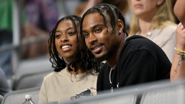 Jun 2, 2024; Fort Worth, Texas, USA; Chicago Bears safety Jonathan Owens watches his wife Simone Biles (not pictured) with her sister Adria as she performs during day two of the women’s 2024 Xfinity U.S. Gymnastics Championships at Dickies Arena. 