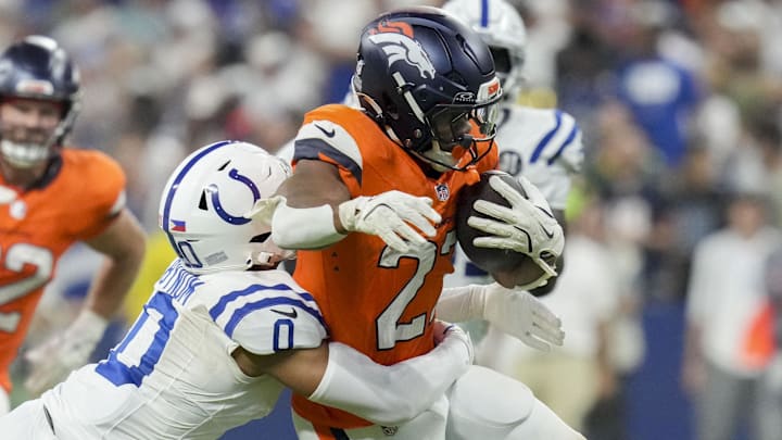 Sep 14, 2025; Indianapolis, Indiana, USA; Indianapolis Colts safety Cam Bynum (0) tackles Denver Broncos running back J.K. Dobbins (27) at Lucas Oil Stadium. Sep 14, 2025; Indianapolis, Indiana, USA; Indianapolis Colts safety Cam Bynum (0) tackles Denver Broncos running back J.K. Dobbins (27) at Lucas Oil Stadium.