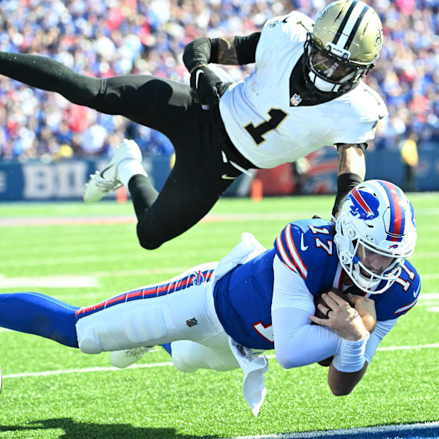 Buffalo Bills quarterback Josh Allen dives for a touchdown past New Orleans Saints cornerback Alontae Taylor.