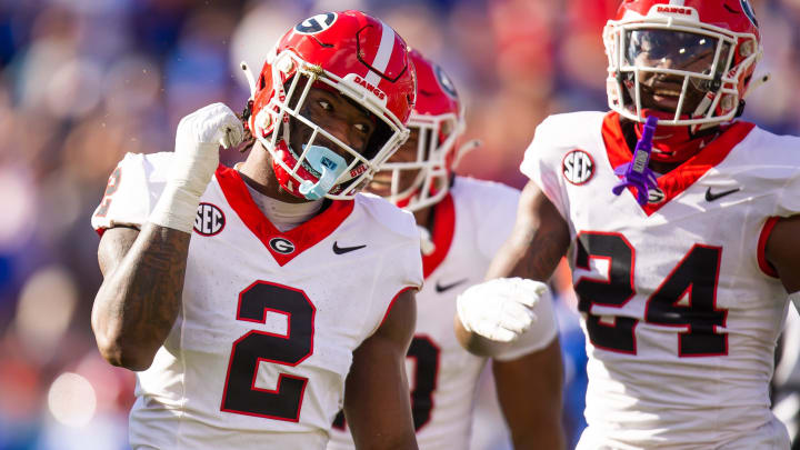 Georgia Bulldogs linebacker Smael Mondon Jr. (2) celebrates his tackle of Florida Gators running back Trevor Etienne (7) at Everbank Stadium in Jacksonville, FL on Saturday, October 28, 2023. [Doug Engle/Gainesville Sun]