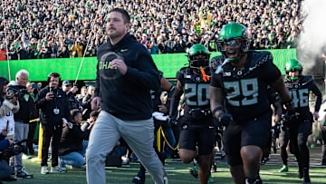Oregon coach Dan Lanning leads his team onto the field for their game against Southern California Nov. 22, 2025.