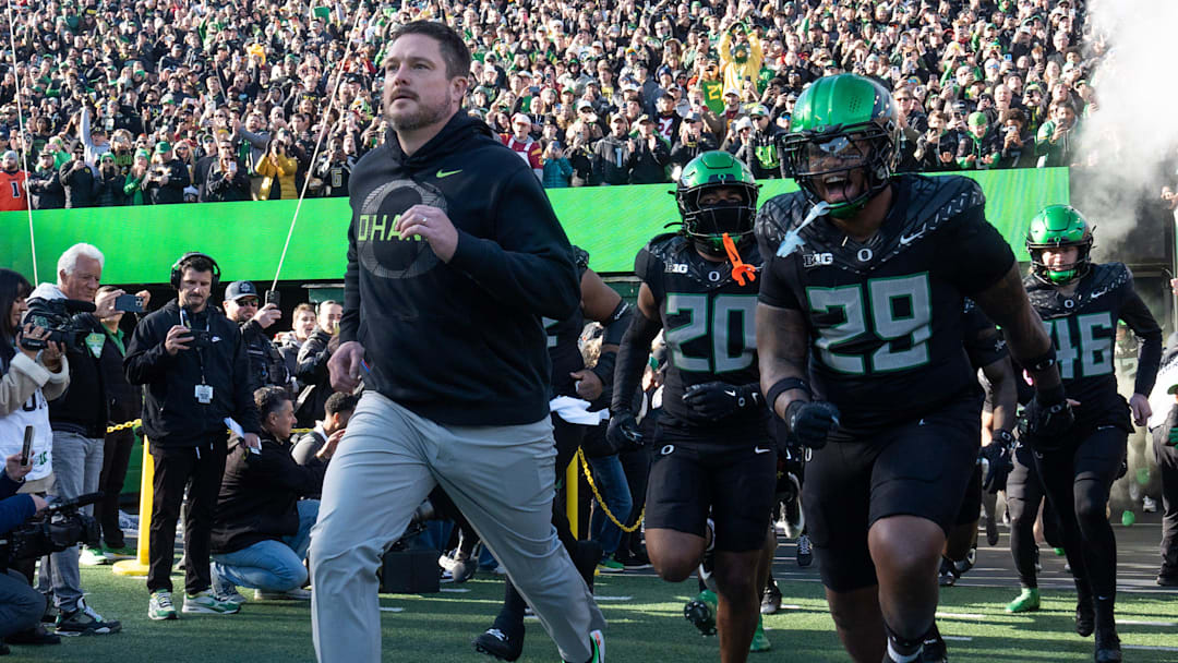 Oregon coach Dan Lanning leads his team onto the field for their game against Southern California Nov. 22, 2025.
