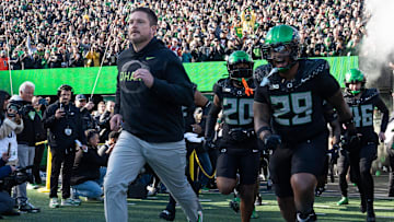 Oregon coach Dan Lanning leads his team onto the field for their game against Southern California Nov. 22, 2025.