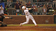 Texas Longhorns catcher Kimble Schuessler hits against the Texas A&M Aggies during the second round in the NCAA baseball College Station Regional