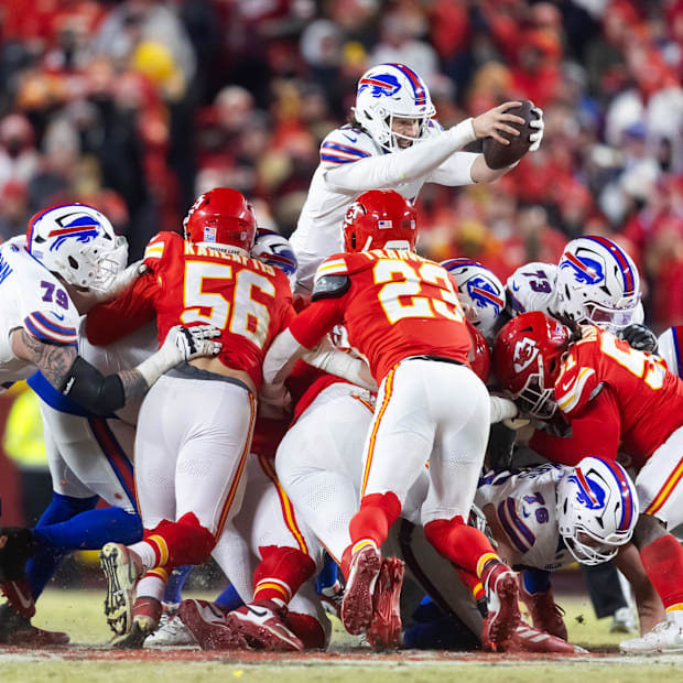 quarterback Josh Allen (17) leaps over the line