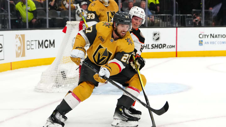 Apr 18, 2024; Las Vegas, Nevada, USA; Vegas Golden Knights defenseman Shea Theodore (27) protects the puck from Anaheim Ducks center Isac Lundestrom (21) during the first period at T-Mobile Arena. Mandatory Credit: Stephen R. Sylvanie-USA TODAY Sports