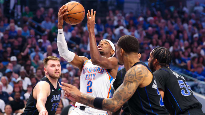 May 18, 2024; Dallas, Texas, USA;  Oklahoma City Thunder guard Shai Gilgeous-Alexander (2) drives to the basket as Dallas Mavericks guard Luka Doncic (77) and Dallas Mavericks forward P.J. Washington (25) defend during the second quarter in game six of the second round of the 2024 NBA playoffs at American Airlines Center. Mandatory Credit: Kevin Jairaj-USA TODAY Sports