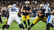 Dec 10, 2023; New Orleans, Louisiana, USA; New Orleans Saints quarterback Derek Carr (4) looks to pass against Carolina Panthers defensive tackle Derrick Brown (95) during the second half at the Caesars Superdome. Mandatory Credit: Stephen Lew-Imagn Images