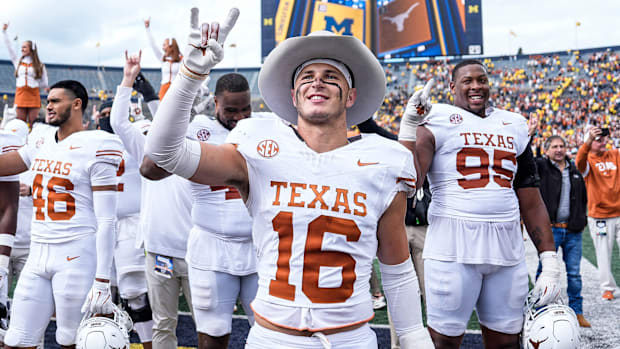 Texas safety Michael Taaffe and fellow Longhorns celebrate 31-12 win over Michigan.