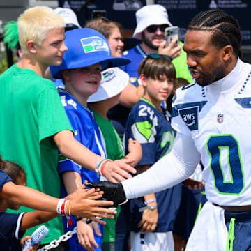 Jul 27, 2024; Renton, WA, USA; Seattle Seahawks linebacker Tyrel Dodson (0) interacts with fans before training camp at Virginia Mason Athletic Center.