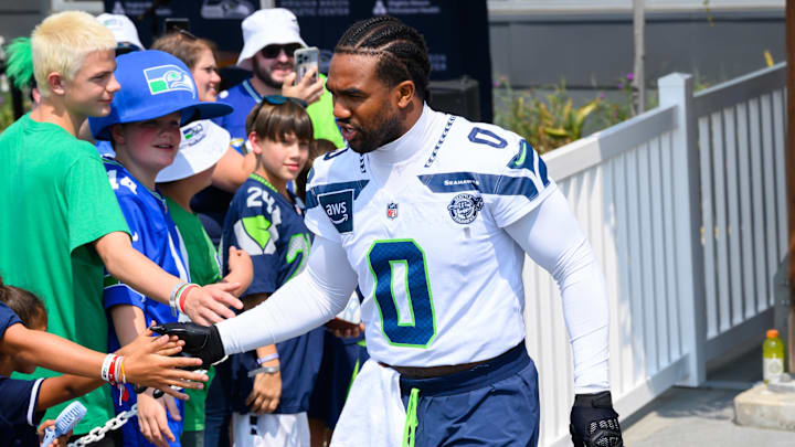 Jul 27, 2024; Renton, WA, USA; Seattle Seahawks linebacker Tyrel Dodson (0) interacts with fans before training camp at Virginia Mason Athletic Center.