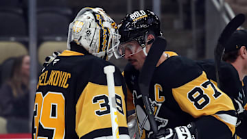 Nov 30, 2024; Pittsburgh, Pennsylvania, USA;  Pittsburgh Penguins goaltender Alex Nedeljkovic (39) and center Sidney Crosby (87) celebrate after defeating the Calgary Flames at PPG Paints Arena. Mandatory Credit: Charles LeClaire-Imagn Images