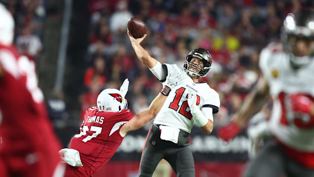 Tampa Bay Buccaneers quarterback Tom Brady (12) throws the ball pressured by Arizona Cardinals