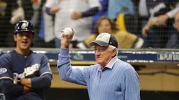 Legendary Brewers radio broadcaster Bob Uecker salutes the crowd after throwing out the first pitch in Game 1 of the National League Championship Series against the Los Angeles Dodgers Oct. 12, 2018, at Miller Park in Milwaukee.