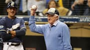 Legendary Brewers radio broadcaster Bob Uecker salutes the crowd after throwing out the first pitch in Game 1 of the National League Championship Series against the Los Angeles Dodgers Oct. 12, 2018, at Miller Park in Milwaukee.