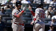 Boston Red Sox shortstop Trevor Story (10) is greeted at home plate by first baseman Nathaniel Lowe (37) after hitting a solo home run against the New York Yankees during the fifth inning at Yankee Stadium.