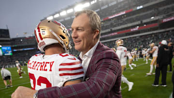 San Francisco 49ers running back Christian McCaffrey (L) and general manager John Lynch (R)