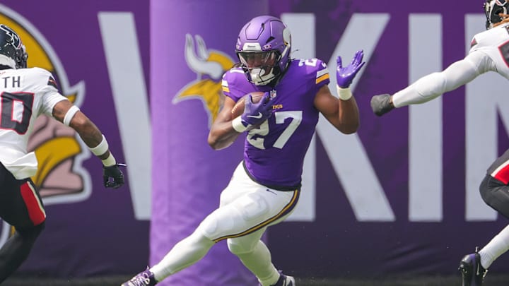 Aug 9, 2025; Minneapolis, Minnesota, USA; Minnesota Vikings running back Jordan Mason (27) runs with the ball against the Houston Texans in the first quarter at U.S. Bank Stadium. Mandatory Credit: Brad Rempel-Imagn Images