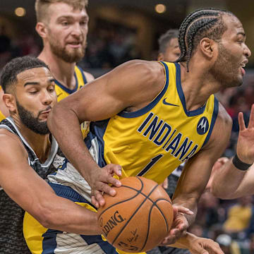 Dec 20, 2019; Indianapolis, IN, USA; Indiana Pacers forward T.J. Warren (1) is fouled by Sacramento Kings guard Corey Joseph (9) in the second half at Bankers Life Fieldhouse. Mandatory Credit: Trevor Ruszkowski-Imagn Images