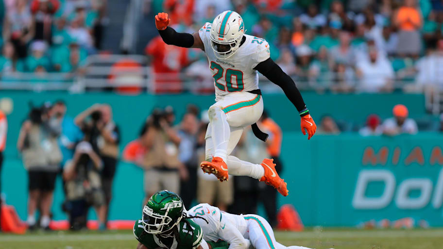 Miami Dolphins linebacker Jordyn Brooks (20) jumps over safety Jordan Poyer (21) and New York Jets wide receiver Davante Adams (17) during the fourth quarter at Hard Rock Stadium last season. | Sam Navarro-Imagn Images