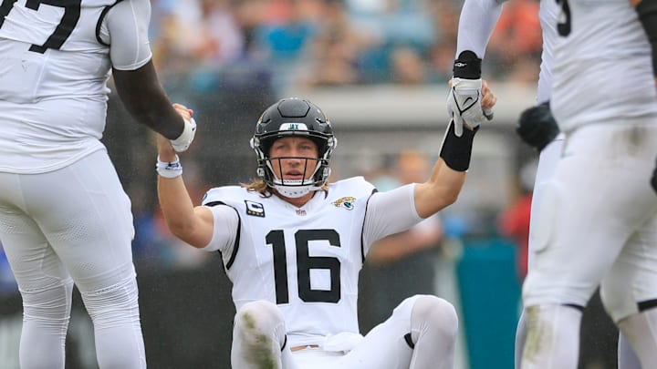 Jacksonville Jaguars quarterback Trevor Lawrence (16) is helped by offensive tackle Anton Harrison (77) and offensive tackle Cam Robinson (74) after being sacked during the third quarter of an NFL football matchup Sunday, Sept. 15, 2024 at EverBank Stadium in Jacksonville, Fla. The Browns defeated the Jaguars 18-13. [Corey Perrine/Florida Times-Union]