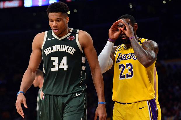 Los Angeles Lakers forward LeBron James (23) reacts toward Milwaukee Bucks forward Giannis Antetokounmpo (34)