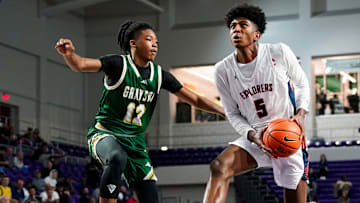 Columbus Explorers guard Jaxon Richardson (5) drives to the basket as Grayson Rams guard Blaze Johnson (12) guards him during the third quarter of a City of Palms Classic quarterfinal game at Suncoast Credit Union Arena in Fort Myers, Fla., on Friday, Dec. 20, 2024.