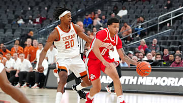 Nov 4, 2024; Las Vegas, Nevada, USA; Ohio State Buckeyes guard John Mobley Jr. (0) dribbles ahead of Texas Longhorns guard Tre Johnson (20) during the second half at T-Mobile Arena. Mandatory Credit: Stephen R. Sylvanie-Imagn Images
