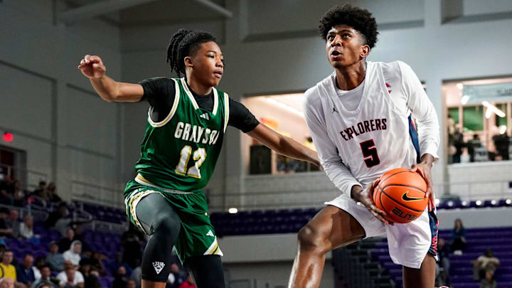 Columbus Explorers guard Jaxon Richardson (5) drives to the basket as Grayson Rams guard Blaze Johnson (12) guards him during the third quarter of a City of Palms Classic quarterfinal game at Suncoast Credit Union Arena in Fort Myers, Fla., on Friday, Dec. 20, 2024.