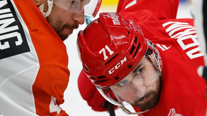 Mar 28, 2026; Detroit, Michigan, USA;  Philadelphia Flyers center Luke Glendening (41) and Detroit Red Wings center Dylan Larkin (71) gets set to face off in the second period at Little Caesars Arena.