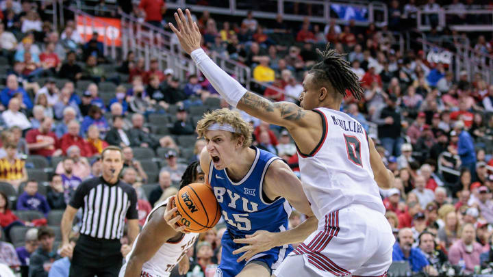 Mar 14, 2024; Kansas City, MO, USA; Brigham Young Cougars guard Dawson Baker (25) drives to the basket around Texas Tech Red Raiders guard Chance McMillian (0) during the second half at T-Mobile Center. Mandatory Credit: William Purnell-USA TODAY Sports