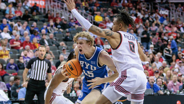 Mar 14, 2024; Kansas City, MO, USA; Brigham Young Cougars guard Dawson Baker (25) drives to the basket around Texas Tech Red Raiders guard Chance McMillian (0) during the second half at T-Mobile Center. Mandatory Credit: William Purnell-USA TODAY Sports